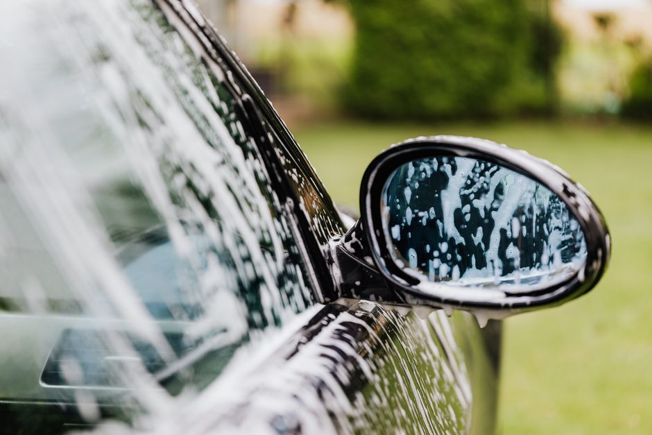 Thick foam applied to a car during a premium auto detailing wash