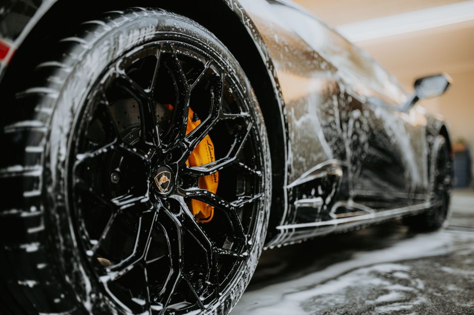 Luxury car receiving premium auto detailing and ceramic coating